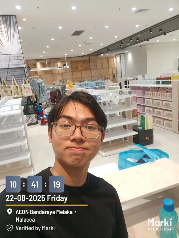 Tan in a store mid fit-out, fixtures and shelving being set up around him.